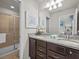 Bathroom with granite countertop, double sinks, and shower at 8832 Macapa Dr, Kissimmee, FL 34747