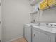 Laundry room with washer, dryer, and shelving for storage at 8832 Macapa Dr, Kissimmee, FL 34747