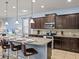 Modern kitchen with dark wood cabinets and a breakfast bar at 8832 Macapa Dr, Kissimmee, FL 34747