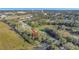 Aerial view showing a single-Gathering home nestled on a lot with mature trees and nearby homes at 101 E Division St, Clermont, FL 34711