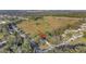 Aerial view of a house on a lot, with a road and surrounding houses visible at 101 E Division St, Clermont, FL 34711