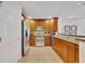 Bright kitchen featuring stainless steel appliances and wood cabinets at 7659 Whisper Way # 102, Reunion, FL 34747