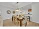 Bright dining area with hardwood floors and a modern chandelier at 7659 Whisper Way # 102, Reunion, FL 34747