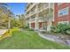 Brick building exterior with balconies and lush landscaping at 7659 Whisper Way # 102, Reunion, FL 34747