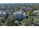 Aerial view showing the building's location within a tree-lined community at 7659 Whisper Way # 102, Reunion, FL 34747