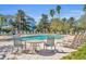 Inviting pool area with comfortable seating and plenty of sunshine at 7659 Whisper Way # 102, Reunion, FL 34747
