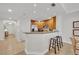 Modern kitchen with a breakfast bar and stainless steel appliances at 7659 Whisper Way # 102, Reunion, FL 34747