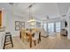 Elegant dining room with hardwood floors and modern light fixture at 7659 Whisper Way # 102, Reunion, FL 34747