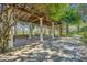 A charming pergola covered in lush greenery creates a shaded sitting area at 7659 Whisper Way # 102, Reunion, FL 34747