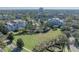 Aerial view of community with condos, green space, and pool area at 7659 Whisper Way # 102, Reunion, FL 34747