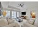 Spacious living room with hardwood floors and access to a patio at 7659 Whisper Way # 102, Reunion, FL 34747