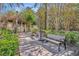 A paved pathway winds through a lush, tree-lined community with benches and a pergola at 7659 Whisper Way # 102, Reunion, FL 34747