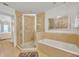 Bathroom with a shower, soaking tub, and view into bedroom at 7659 Whisper Way # 102, Reunion, FL 34747
