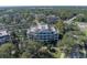 Aerial view of a community with lush landscaping and a multi-story building at 7659 Whisper Way # 102, Reunion, FL 34747
