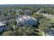 An aerial view showcasing the building's design and surrounding landscape at 7659 Whisper Way # 102, Reunion, FL 34747