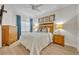 Cozy bedroom with a queen bed and wood dresser at 7659 Whisper Way # 102, Reunion, FL 34747