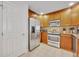 Modern kitchen with stainless steel appliances and wood cabinets at 7659 Whisper Way # 102, Reunion, FL 34747