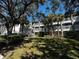 Exterior view of an apartment building with balconies and lush landscaping at 14013 Fairway Island Dr # 415, Orlando, FL 32837