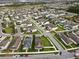 Aerial view of a residential neighborhood with a focus on a house featuring solar panels at 6275 Hamlin Reserve Blvd, Winter Garden, FL 34787