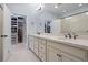 Double vanity bathroom with a large walk in closet at 6275 Hamlin Reserve Blvd, Winter Garden, FL 34787