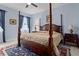 Spacious bedroom with a large four poster bed and ensuite bathroom at 6275 Hamlin Reserve Blvd, Winter Garden, FL 34787