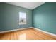 Spacious bedroom with hardwood floors and a large window offering a view at 6275 Hamlin Reserve Blvd, Winter Garden, FL 34787