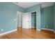 Light and airy bedroom with hardwood floors and built-in closet at 6275 Hamlin Reserve Blvd, Winter Garden, FL 34787