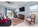 Gathering room with access to backyard and home gym at 6275 Hamlin Reserve Blvd, Winter Garden, FL 34787