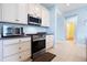 Bright kitchen with stainless steel appliances and white cabinets at 6275 Hamlin Reserve Blvd, Winter Garden, FL 34787