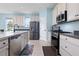 Modern kitchen with island, stainless steel appliances, and light blue cabinets at 6275 Hamlin Reserve Blvd, Winter Garden, FL 34787