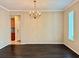 Bright dining room with dark hardwood floors and a chandelier at 8426 Morehouse Dr, Orlando, FL 32836