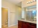Bathroom with granite countertops, a large mirror, and a walk-in shower at 8426 Morehouse Dr, Orlando, FL 32836