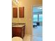 Small bathroom with granite vanity and view into bedroom at 8426 Morehouse Dr, Orlando, FL 32836