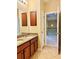 Bathroom with double vanity and access to a loft area at 8426 Morehouse Dr, Orlando, FL 32836