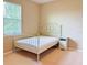 Bedroom with a white metal bed frame and small nightstand at 8426 Morehouse Dr, Orlando, FL 32836