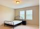 Bedroom with a black metal bed frame and nightstand at 8426 Morehouse Dr, Orlando, FL 32836