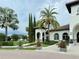 Community clubhouse with palm trees and walkway at 8426 Morehouse Dr, Orlando, FL 32836