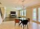 Dining area with glass table and four chairs, view of Gathering room and backyard at 8426 Morehouse Dr, Orlando, FL 32836