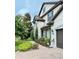 Side view of house showing stone accents and landscaping at 8426 Morehouse Dr, Orlando, FL 32836