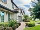 Side view of house showcasing landscaping and brick driveway at 8426 Morehouse Dr, Orlando, FL 32836