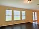 Gathering room with hardwood floors, large windows, and access to backyard at 8426 Morehouse Dr, Orlando, FL 32836