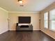 Gathering room with large TV, dark hardwood floors, and plenty of natural light at 8426 Morehouse Dr, Orlando, FL 32836