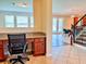 Home office with granite countertop and view of Gathering room at 8426 Morehouse Dr, Orlando, FL 32836