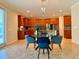 Open kitchen with breakfast nook, wood cabinets, and a center island at 8426 Morehouse Dr, Orlando, FL 32836