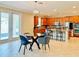 Kitchen features breakfast nook with glass table and four blue chairs, access to backyard at 8426 Morehouse Dr, Orlando, FL 32836