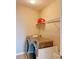 Laundry room with washer, dryer, and shelving for storage at 8426 Morehouse Dr, Orlando, FL 32836