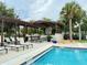 Resort-style pool with pergola, lounge chairs, and outdoor kitchen at 8426 Morehouse Dr, Orlando, FL 32836