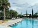 Community pool with lounge chairs and a play area at 8426 Morehouse Dr, Orlando, FL 32836