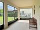 Screened porch with wooden benches and backyard view at 8426 Morehouse Dr, Orlando, FL 32836