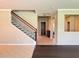 Elegant staircase with wrought iron railing and view of entryway at 8426 Morehouse Dr, Orlando, FL 32836